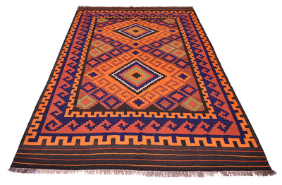 Colorful vintage Kilim rug with central diamond design in orange, blue, and rust; fringed.