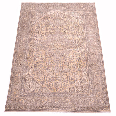 A rectangular traditional area carpet with an intricate floral geometric pattern, with beige, brown and golden beige tonalities shown flat against a solid white background.