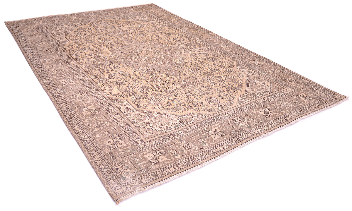 A traditional oriental vintage carpet with an intricate floral-geometric pattern in muted beige, brown, anf beige gold tones, shown from an elevated angle on a white background.