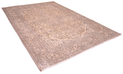 A traditional oriental vintage carpet with an intricate floral-geometric pattern in muted beige, brown, anf beige gold tones, shown from an elevated angle on a white background.