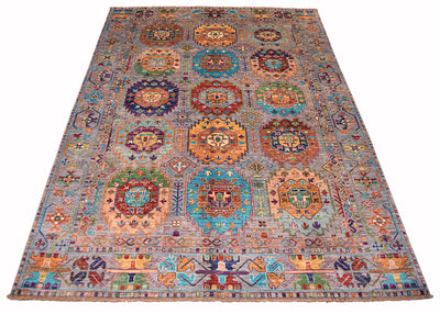 A handmade Afghan Waziri tribal rug with a traditional Turkmen-style design, featuring multiple colourful medallions and intricate geometric patterns on a muted grey background.