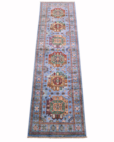 A 3m long rectangular Afghan Waziri runner with a light blue field and multiple ornate medallion motifs in red, green, beige, and brown, shown flat against a white background.