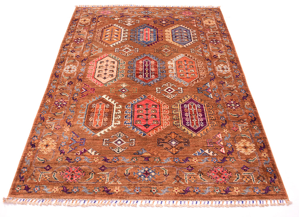 A traditional hand-knotted wool Waziri area rug with a warm brown base and intricate geometric medallion patterns in red, blue, purple, and beige, shown flat against a white background.