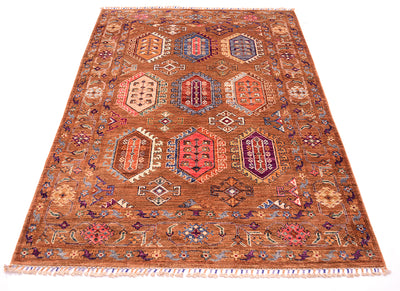 A traditional hand-knotted wool Waziri area rug with a warm brown base and intricate geometric medallion patterns in red, blue, purple, and beige, shown flat against a white background.