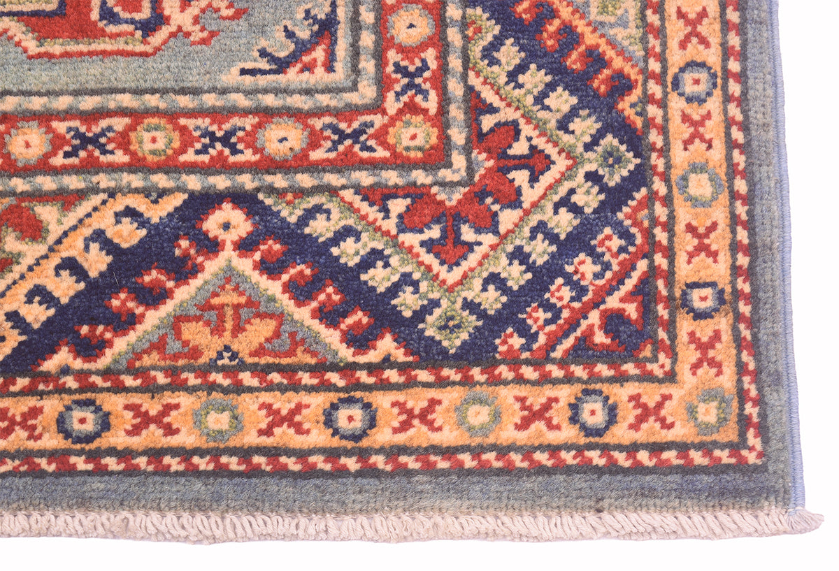 Handmade Afghan Yakash Kazak rug corner with border details and light fringed edge
