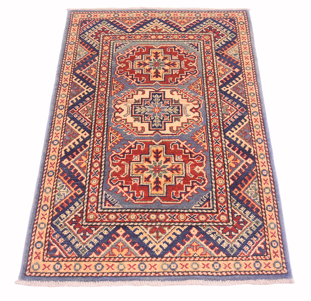 Handmade Afghan Yakash Kazak rug front view with repeating diamond motifs and red blue accents