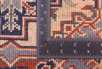 Handmade Afghan Yakash Kazak rug fabric close-up with measuring tape for size reference