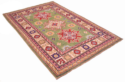 Handmade green wool rug, diagonal view, red medallions and ornamental border