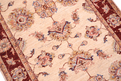 Close  up and detail of Ziegler design rug with palmettes and floral blossoms. Minor borders in golden beige with a rust red border background. 