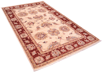 Angled view of handknotted Ziegler Rug with larg palmettes and decorative border. Rust red border and icory cream field.