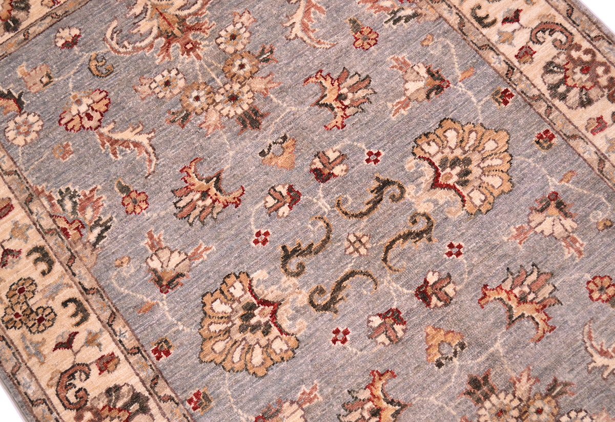 Detail of handwoven rug with natural vegetable dyes with palmettes and floral sprays, and flowering blossom