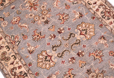 Detail of handwoven rug with natural vegetable dyes with palmettes and floral sprays, and flowering blossom