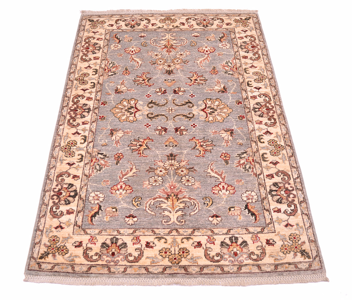 Floral border and main field of afghan ziegler rug with cream motifs and punctiations of pinks, red and golden tones