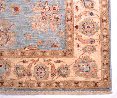 Handmade Afghan Ziegler rug corner detail, light blue field with orange medallions