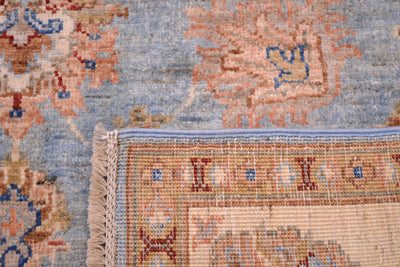 Handmade Afghan Ziegler rug close-up edge with fringed border and blue-orange pattern