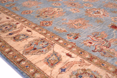 Handmade Afghan Ziegler rug close-up border, cream stripe with blue and orange accents
