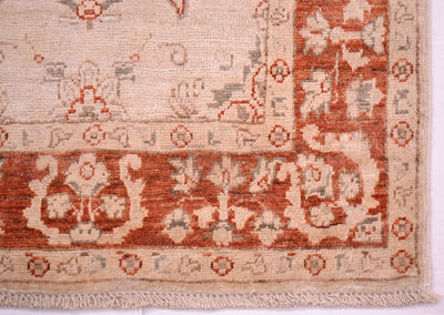 Corner detail of Afgan runner in cream and rust terracotta with grey detailing woven on cotton warps