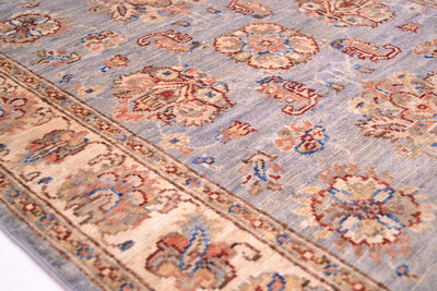 Detail of border of Ziegler runner in soft blue greys and creams