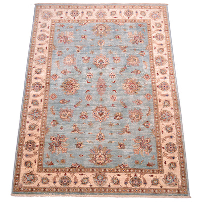 All over floral design with light topaz blue field and handknotted pure wool pile