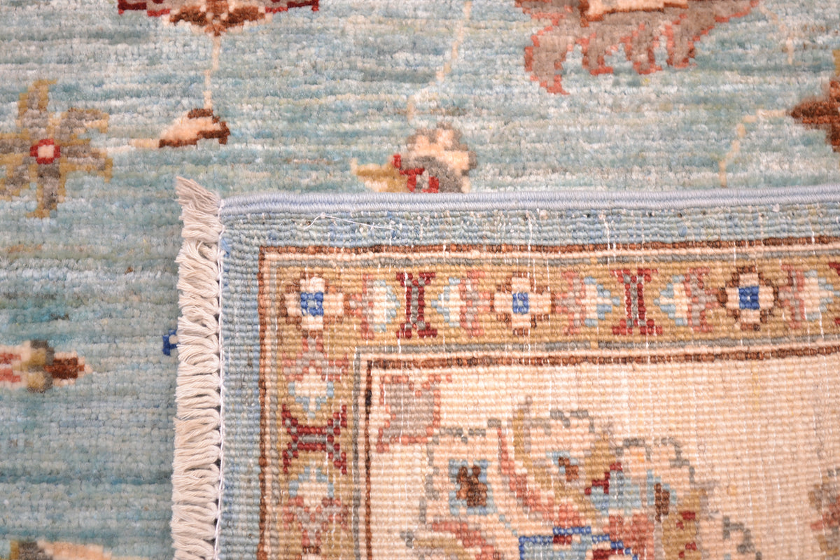 Reverse of rug showing knotting and main field colour of light topaz blue 