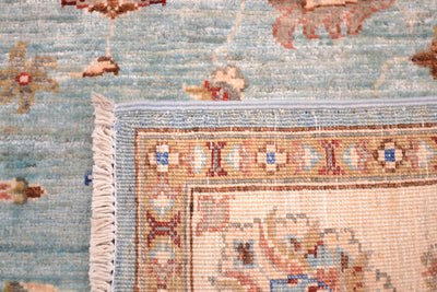 Reverse of rug showing knotting and main field colour of light topaz blue 