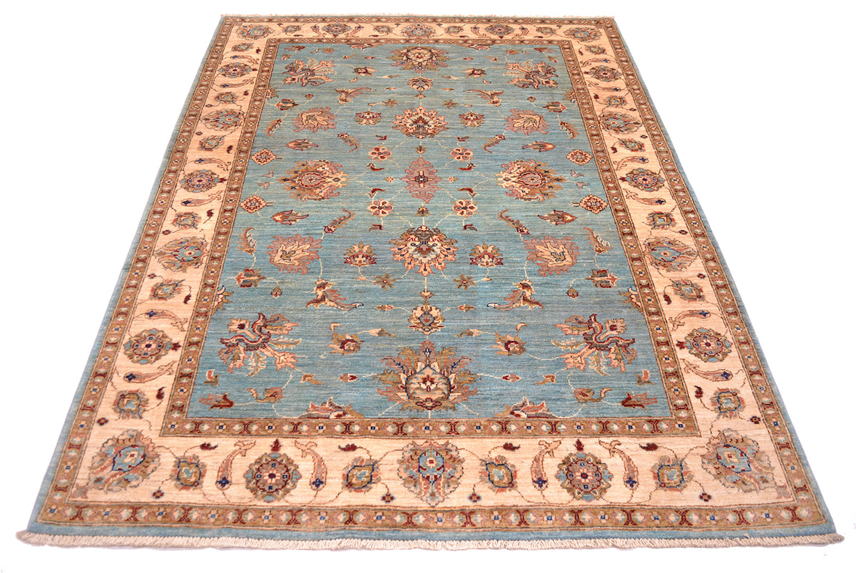 Classic and traditional design of a handmage carpet in soft colours of blue and cream