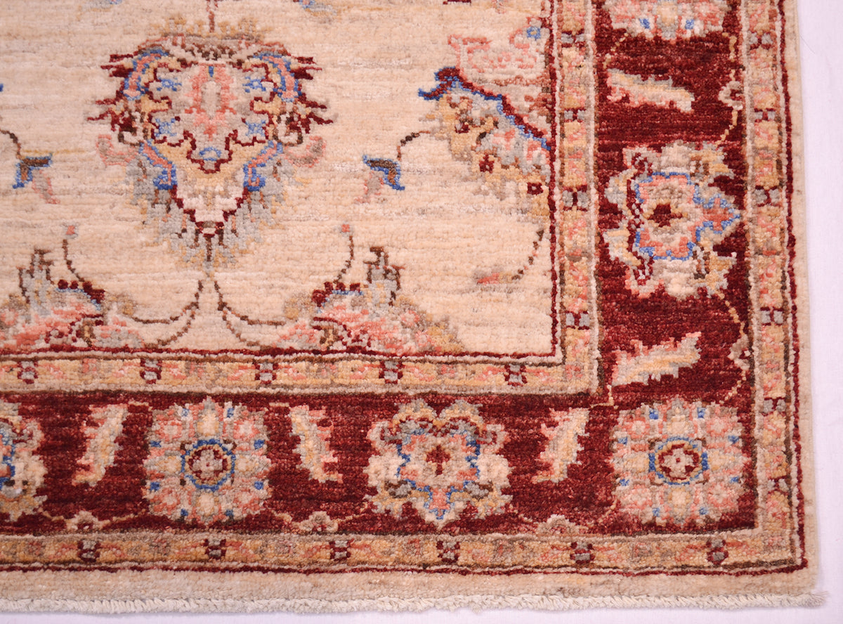 Corner detail of Afghan Runner rug with elegant palmettes in the main field and border. Short cotton fringe warps.