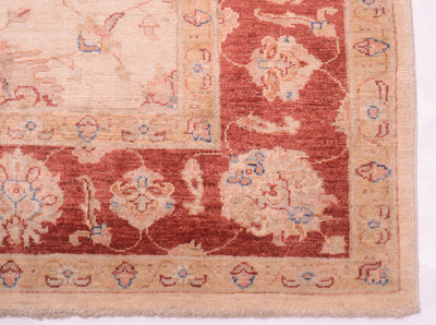 Detail of corner of handknotted afghan ziegler carpet with cotton warp fringes and palmette border.