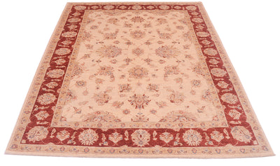Pure wool pile pf classic ziegler design carpet with multiple floral motifs and cream field and rich red and cream decorative border.