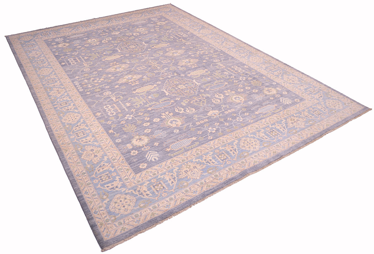 Pastel blue patterned area rug laid diagonally with ornate border