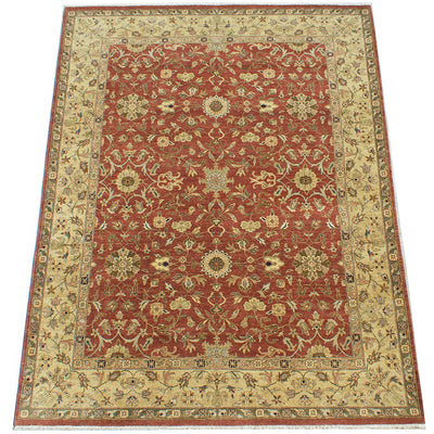 Overall view of handwoven room size carpet with Ziegler Design and flowing floral field and border. Border has beige, brown and golden olive tones. The field a warming amber rust backgrouns. With handspun wool and quality chrome dyes.