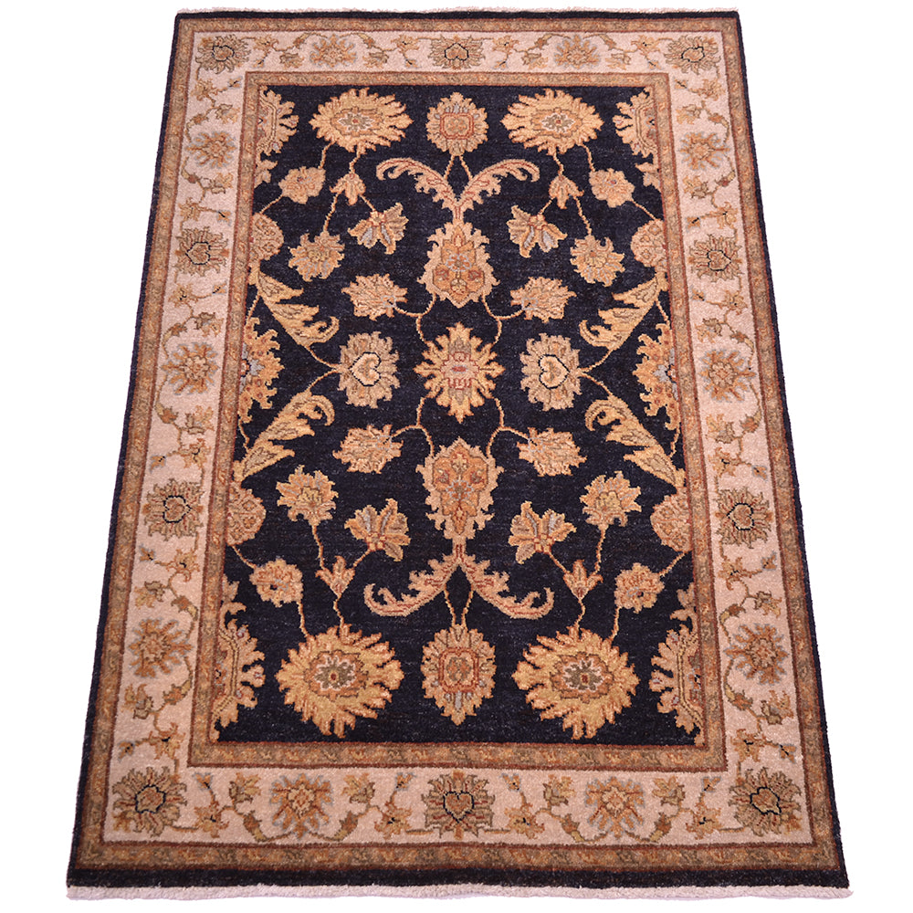 Floral area rug with dark navy center, tan border, and gold-rust medallion accents