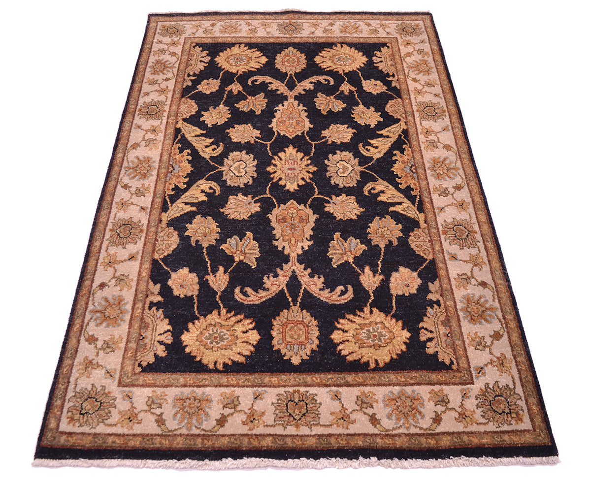 Floral area rug with dark navy field, tan border, and rust-gold floral ornaments
