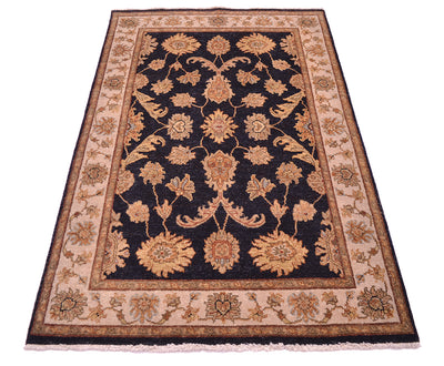 Floral area rug with dark navy field, tan border, and rust-gold floral ornaments