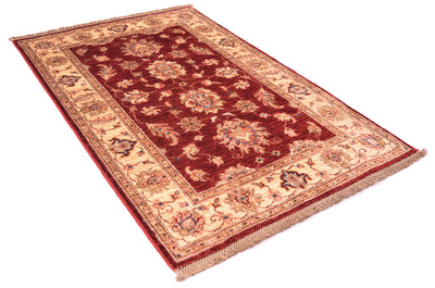 Handmade Afghan rug in traditional Ziegler floral design in rich reds and golden cream border. 