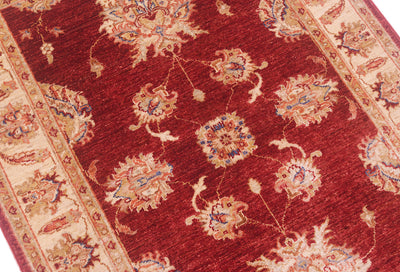 Close up of main field of Ziegler design rug with terracotta pink and blue outlining.