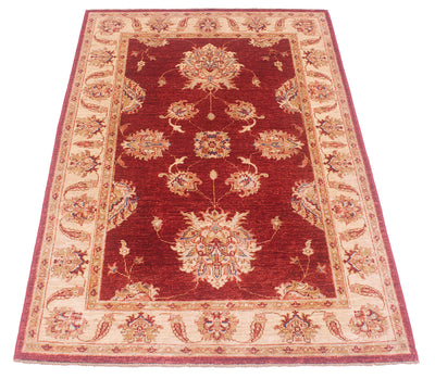 Detail of spacious format of red field of handknotted Afghan Ziegler Rug.