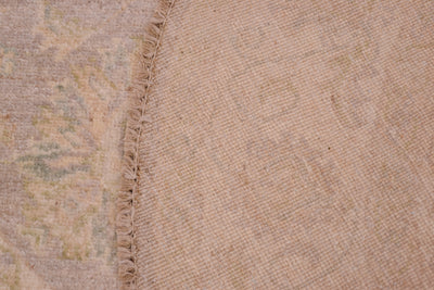 Reverse of soft coloured afghan ziegler rug showing back of knots and cotton foundation warps.
