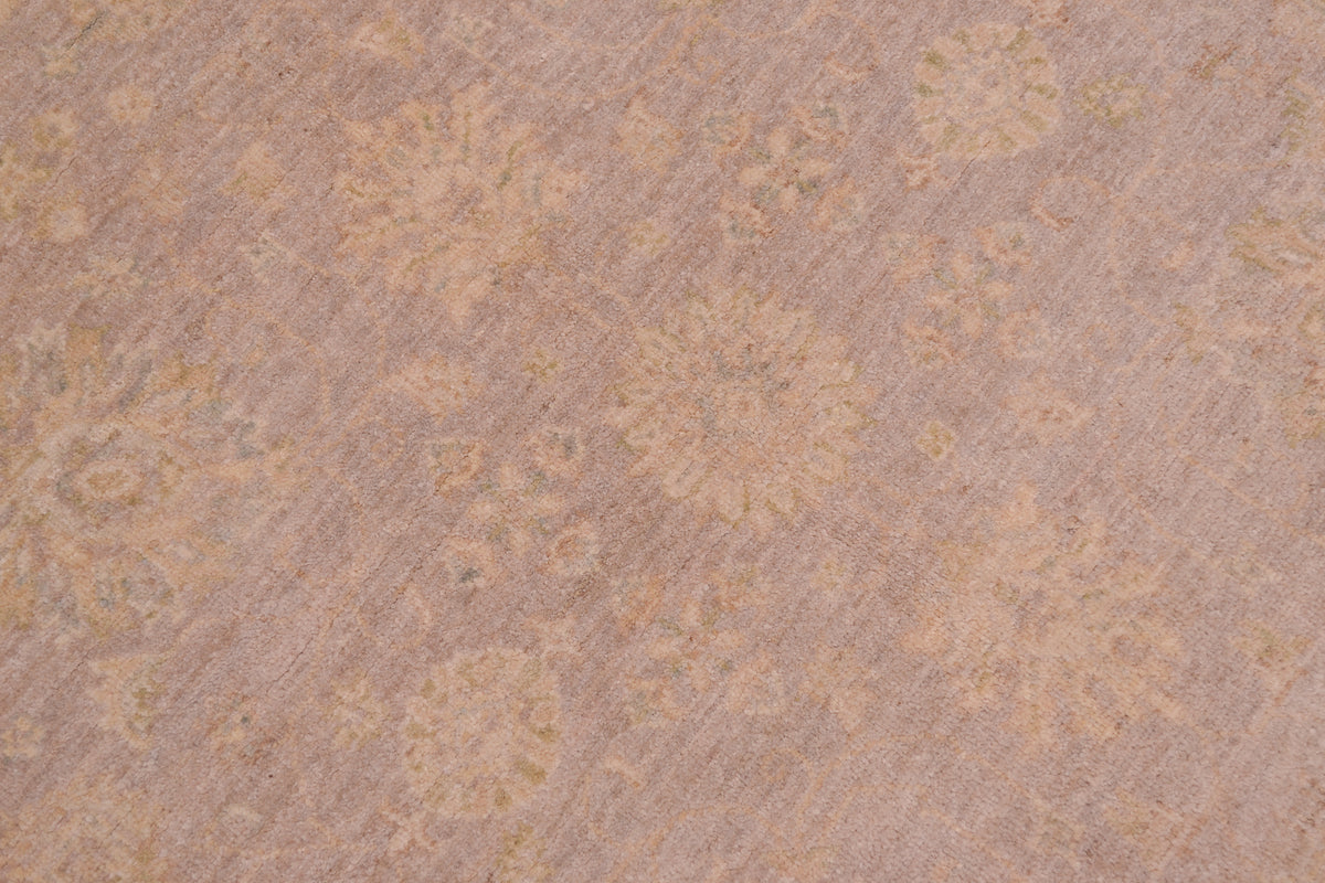 Detail of soft grey field of circular handknotted ziegler rug with touches of beigh and pastel hues