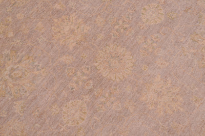 Detail of soft grey field of circular handknotted ziegler rug with touches of beigh and pastel hues
