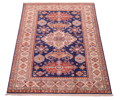 A traditional oriental area rug with a navy blue center field, featuring intricate floral and geometric motifs in red, beige, and cream, surrounded by a patterned border on a white background.