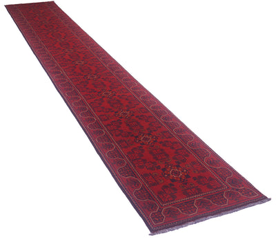A long red afghan runner rug with a dark navy blue border and central geometric pattern, shown diagonally on a plain white background.