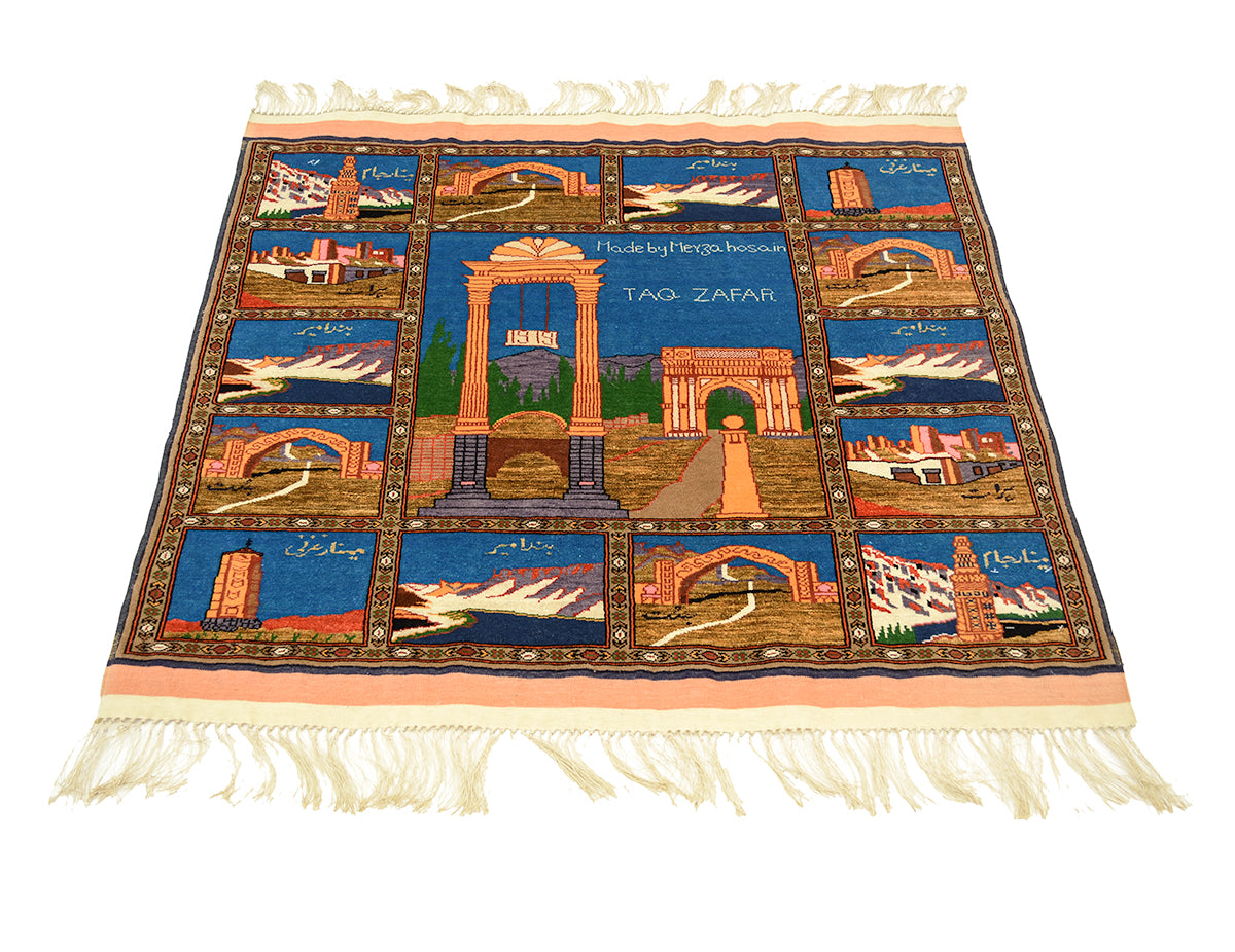 A Fine Pictorial Afghan Kabul Mauri rug featuring a detailed travel illustration of Taq Zafar and other Afghan landmarks, with cream-colored fringe on all sides, shown against a plain white background.