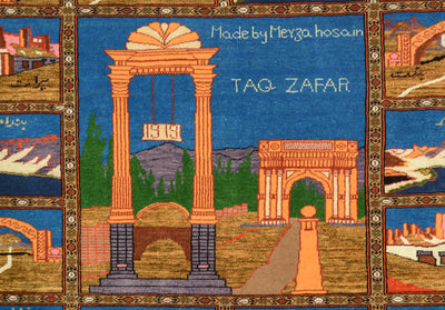 A fine silk and wool hand-knotted Pictorial Afghan rug or mat featuring a stylised architectural scene with large peach-coloured arches and pillars, blue sky-like background areas, green trees, and smaller inset scenes around the border. White text reads 'Made by Merza hosain' and 'TAQ ZAFAR'.