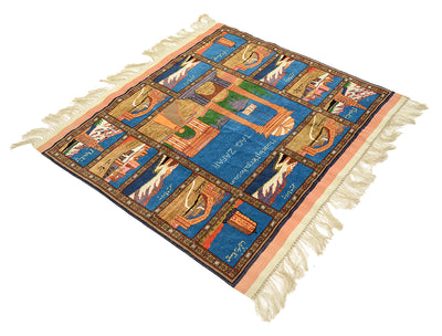 A Fine Kabul Taq Zafar Pictorial Afghan rug with cream fringe on all sides, featuring a architectural monument theme in blue, beige, brown, and orange. The rug is photographed from an elevated angle against a solid white background.